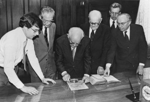 "Mark Hofmann watches as Mormon leaders inspect some of Hofmann's documents." Special Collections Dept., J. Willard Marriott Library, University of Utah.